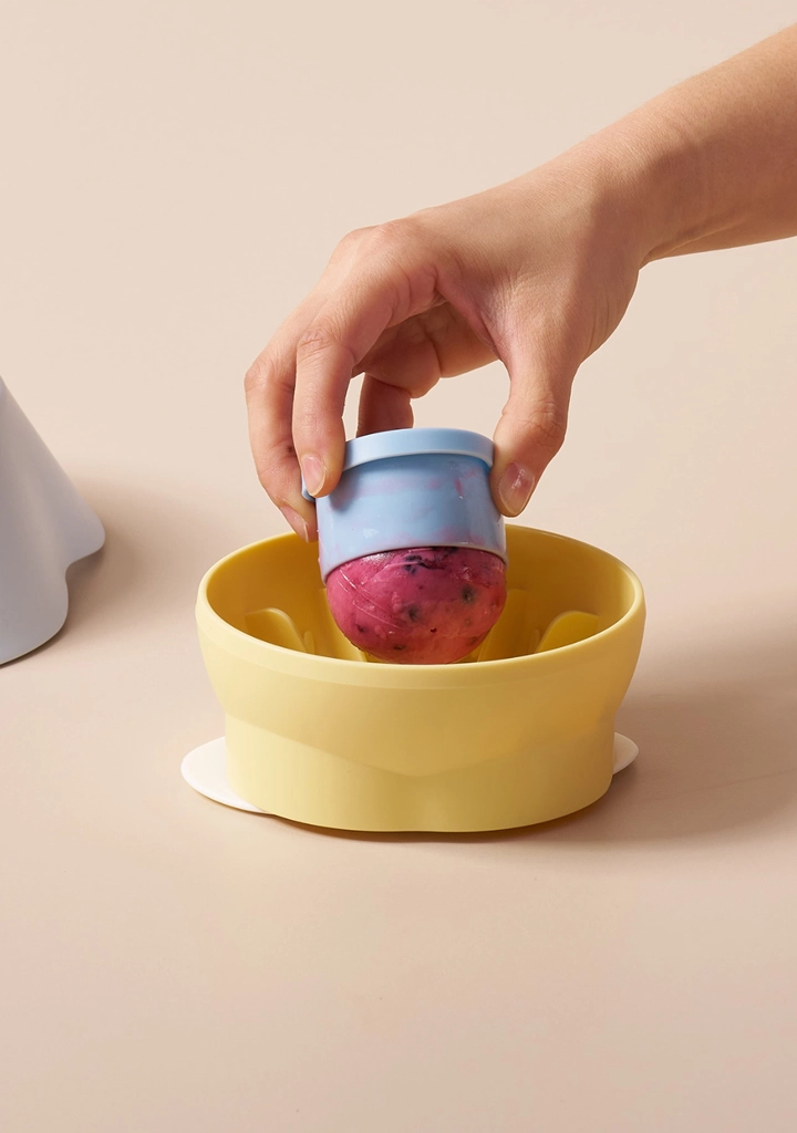 Popping the frozen treat into the bowl