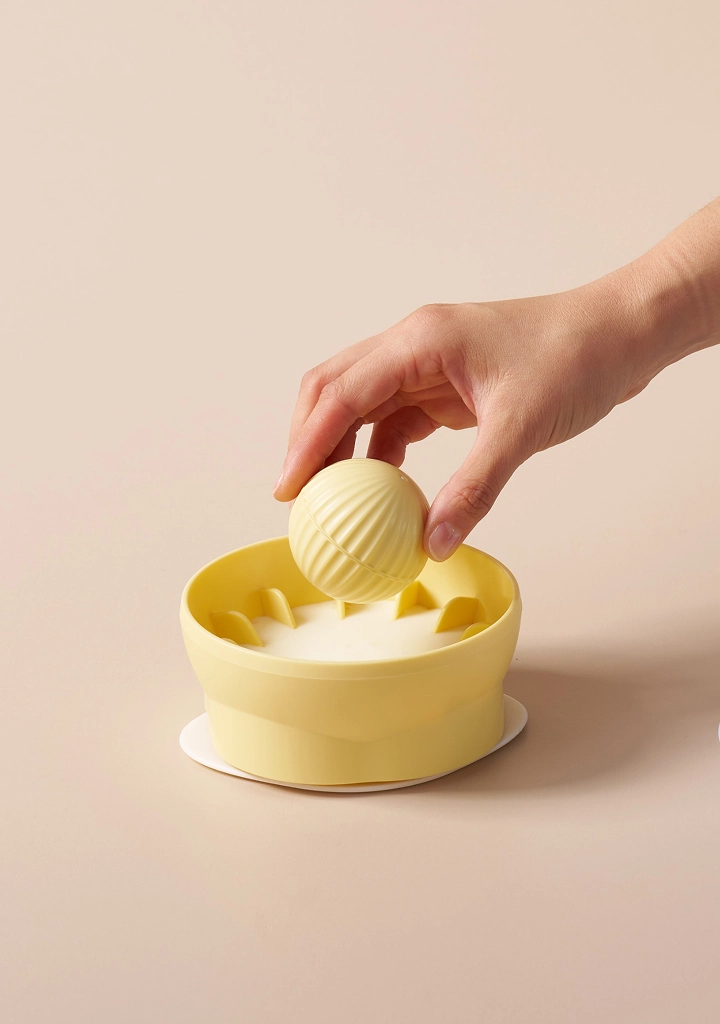 Adding the treat ball to the bowl