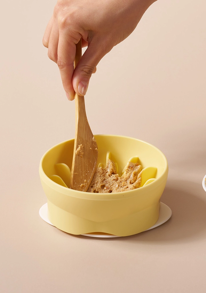 Spreading a soft treat in the bowl